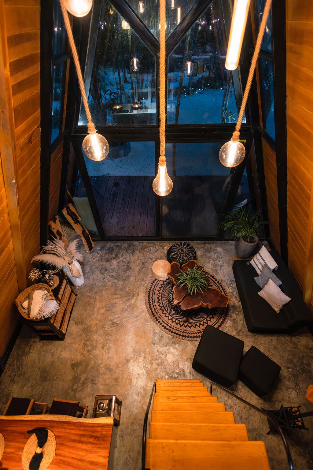 A-frame cabin interior viewed from the loft at Casa Tattva