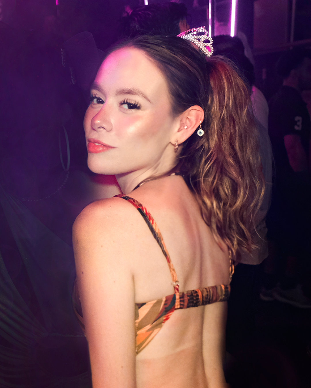 Woman dancing under purple and blue lights at Mandala Club Cancún nightlife